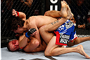 MONTREAL, QC - NOVEMBER 17:  Pablo Garza (R) grapples against Mark Hominick in their featherweight bout during UFC 154 on November 17, 2012  at the Bell Centre in Montreal, Canada.  (Photo by Josh Hedges/Zuffa LLC/Zuffa LLC via Getty Images)
