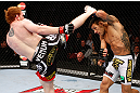 MONTREAL, QC - NOVEMBER 17:  Rafael dos Anjos (R)  blocks a kick from Mark Bocek in their lightweight bout during UFC 154 on November 17, 2012  at the Bell Centre in Montreal, Canada.  (Photo by Josh Hedges/Zuffa LLC/Zuffa LLC via Getty Images)
