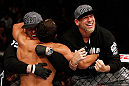 MONTREAL, QC - NOVEMBER 17:  Johny Hendricks celebrates with his corner after knocking out Martin Kampmann with a left in the first round to win their welterweight bout during UFC 154 on November 17, 2012  at the Bell Centre in Montreal, Canada.  (Photo by Josh Hedges/Zuffa LLC/Zuffa LLC via Getty Images)