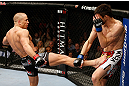 MONTREAL, QC - NOVEMBER 17:  Georges St-Pierre (L) throws a kick against Carlos Condit in their welterweight title bout during UFC 154 on November 17, 2012  at the Bell Centre in Montreal, Canada.  (Photo by Josh Hedges/Zuffa LLC/Zuffa LLC via Getty Images)