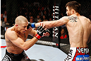 MONTREAL, QC - NOVEMBER 17:  Carlos Condit (R) lands a punch against Georges St-Pierre in their welterweight title bout during UFC 154 on November 17, 2012  at the Bell Centre in Montreal, Canada.  (Photo by Josh Hedges/Zuffa LLC/Zuffa LLC via Getty Images)