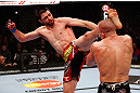 MONTREAL, QC - NOVEMBER 17:  Carlos Condit lands a left footed kick to the head of Georges St-Pierre in their welterweight title bout during UFC 154 on November 17, 2012  at the Bell Centre in Montreal, Canada.  (Photo by Josh Hedges/Zuffa LLC/Zuffa LLC via Getty Images)