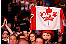 MONTREAL, QC - NOVEMBER 17:  A fan holds up a canadian flag with a UFC logo on it during the fight between Alessio Sakara and Patrick Cote during UFC 154 on November 17, 2012  at the Bell Centre in Montreal, Canada.  (Photo by Josh Hedges/Zuffa LLC/Zuffa LLC via Getty Images)