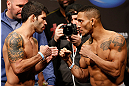 SEATTLE, WA - DECEMBER 07:  (L-R) Opponents Raphael Assuncao and Mike Easton face off during the official UFC on FOX weigh in on December 7, 2012 at Key Arena in Seattle, Washington.  (Photo by Josh Hedges/Zuffa LLC/Zuffa LLC via Getty Images)