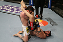 SEATTLE, WA - DECEMBER 08:  John Albert (R) attempts to submit Scott Jorgensen (L) during their bantamweight bout at the UFC on FOX event on December 8, 2012  at Key Arena in Seattle, Washington.  (Photo by Ezra Shaw/Zuffa LLC/Zuffa LLC via Getty Images) *** Local Caption *** Scott Jorgensen; John Albert