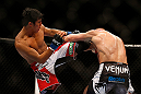 SEATTLE, WA - DECEMBER 08:  (L-R) Nam Phan kicks Dennis Siverduring their featherweight bout at the UFC on FOX event on December 8, 2012  at Key Arena in Seattle, Washington.  (Photo by Josh Hedges/Zuffa LLC/Zuffa LLC via Getty Images) *** Local Caption *** Dennis Siver; Nam Phan