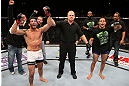 SEATTLE, WA - DECEMBER 08:  Raphael Assuncao (left) reacts to being declared the winner over Mike Easton (right) after their bantamweight bout at the UFC on FOX event on December 8, 2012  at Key Arena in Seattle, Washington.  (Photo by Ezra Shaw/Zuffa LLC/Zuffa LLC via Getty Images) *** Local Caption *** Raphael Assuncao; Mike Easton