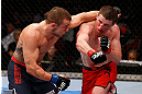 GOLD COAST, AUSTRALIA - DECEMBER 15:  (R-L) Brendan Loughnane and Mike Wilkinson trade punches during their lightweight fight at the UFC on FX event on December 15, 2012  at Gold Coast Convention and Exhibition Centre in Gold Coast, Australia.  (Photo by Josh Hedges/Zuffa LLC/Zuffa LLC via Getty Images)