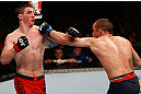 GOLD COAST, AUSTRALIA - DECEMBER 15:  (R-L) Mike Wilkinson punches Brendan Loughnane during their lightweight fight at the UFC on FX event on December 15, 2012  at Gold Coast Convention and Exhibition Centre in Gold Coast, Australia.  (Photo by Josh Hedges/Zuffa LLC/Zuffa LLC via Getty Images)