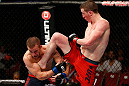 GOLD COAST, AUSTRALIA - DECEMBER 15:  (R-L) Brendan Loughnane delivers a flying knee against Mike Wilkinson during their lightweight fight at the UFC on FX event on December 15, 2012  at Gold Coast Convention and Exhibition Centre in Gold Coast, Australia.  (Photo by Josh Hedges/Zuffa LLC/Zuffa LLC via Getty Images)