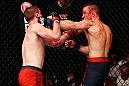 GOLD COAST, AUSTRALIA - DECEMBER 15:  (R-L) Mike Wilkinson punches Brendan Loughnane during their lightweight fight at the UFC on FX event on December 15, 2012  at Gold Coast Convention and Exhibition Centre in Gold Coast, Australia.  (Photo by Josh Hedges/Zuffa LLC/Zuffa LLC via Getty Images)
