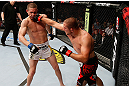 GOLD COAST, AUSTRALIA - DECEMBER 15:  (R-L) Mike Pierce punches Seth Baczynski during their welterweight fight at the UFC on FX event on December 15, 2012  at Gold Coast Convention and Exhibition Centre in Gold Coast, Australia.  (Photo by Josh Hedges/Zuffa LLC/Zuffa LLC via Getty Images)