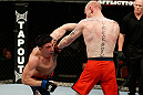 GOLD COAST, AUSTRALIA - DECEMBER 15:  (L-R) Norman Parke punches Colin Fletcher during their lightweight fight at the UFC on FX event on December 15, 2012  at Gold Coast Convention and Exhibition Centre in Gold Coast, Australia.  (Photo by Josh Hedges/Zuffa LLC/Zuffa LLC via Getty Images)