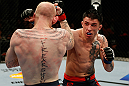GOLD COAST, AUSTRALIA - DECEMBER 15:  (R-L) Norman Parke punches Colin Fletcher during their lightweight fight at the UFC on FX event on December 15, 2012  at Gold Coast Convention and Exhibition Centre in Gold Coast, Australia.  (Photo by Josh Hedges/Zuffa LLC/Zuffa LLC via Getty Images)