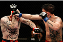 GOLD COAST, AUSTRALIA - DECEMBER 15:  (R-L) Norman Parke punches Colin Fletcher during their lightweight fight at the UFC on FX event on December 15, 2012  at Gold Coast Convention and Exhibition Centre in Gold Coast, Australia.  (Photo by Josh Hedges/Zuffa LLC/Zuffa LLC via Getty Images)
