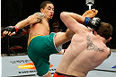GOLD COAST, AUSTRALIA - DECEMBER 15:  (L-R) Robert Whittaker kicks Bradley Scott during their welterweight fight at the UFC on FX event on December 15, 2012  at Gold Coast Convention and Exhibition Centre in Gold Coast, Australia.  (Photo by Josh Hedges/Zuffa LLC/Zuffa LLC via Getty Images)