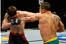 GOLD COAST, AUSTRALIA - DECEMBER 15:  (R-L) Robert Whittaker punches Bradley Scott during their welterweight fight at the UFC on FX event on December 15, 2012  at Gold Coast Convention and Exhibition Centre in Gold Coast, Australia.  (Photo by Josh Hedges/Zuffa LLC/Zuffa LLC via Getty Images)