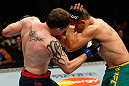 GOLD COAST, AUSTRALIA - DECEMBER 15:  (L-R) Bradley Scott punches Robert Whittaker during their welterweight fight at the UFC on FX event on December 15, 2012  at Gold Coast Convention and Exhibition Centre in Gold Coast, Australia.  (Photo by Josh Hedges/Zuffa LLC/Zuffa LLC via Getty Images)