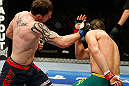GOLD COAST, AUSTRALIA - DECEMBER 15:  (L-R) Bradley Scott punches Robert Whittaker during their welterweight fight at the UFC on FX event on December 15, 2012  at Gold Coast Convention and Exhibition Centre in Gold Coast, Australia.  (Photo by Josh Hedges/Zuffa LLC/Zuffa LLC via Getty Images)