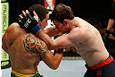 GOLD COAST, AUSTRALIA - DECEMBER 15:  (L-R) Robert Whittaker punches Bradley Scott during their welterweight fight at the UFC on FX event on December 15, 2012  at Gold Coast Convention and Exhibition Centre in Gold Coast, Australia.  (Photo by Josh Hedges/Zuffa LLC/Zuffa LLC via Getty Images)
