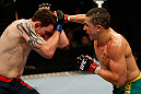 GOLD COAST, AUSTRALIA - DECEMBER 15:  (R-L) Robert Whittaker punches Bradley Scott during their welterweight fight at the UFC on FX event on December 15, 2012  at Gold Coast Convention and Exhibition Centre in Gold Coast, Australia.  (Photo by Josh Hedges/Zuffa LLC/Zuffa LLC via Getty Images)
