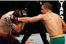 GOLD COAST, AUSTRALIA - DECEMBER 15:  (R-L) Robert Whittaker punches Bradley Scott during their welterweight fight at the UFC on FX event on December 15, 2012  at Gold Coast Convention and Exhibition Centre in Gold Coast, Australia.  (Photo by Josh Hedges/Zuffa LLC/Zuffa LLC via Getty Images)