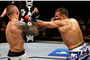 GOLD COAST, AUSTRALIA - DECEMBER 15:  (R-L) George Sotiropoulos punches Ross Pearson during their lightweight fight at the UFC on FX event on December 15, 2012  at Gold Coast Convention and Exhibition Centre in Gold Coast, Australia.  (Photo by Josh Hedges/Zuffa LLC/Zuffa LLC via Getty Images)