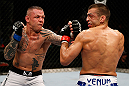 GOLD COAST, AUSTRALIA - DECEMBER 15:  (L-R) Ross Pearson punches George Sotiropoulos during their lightweight fight at the UFC on FX event on December 15, 2012  at Gold Coast Convention and Exhibition Centre in Gold Coast, Australia.  (Photo by Josh Hedges/Zuffa LLC/Zuffa LLC via Getty Images)