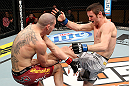 LAS VEGAS, NV - DECEMBER 15:  (R-L) Timothy Elliott kicks Jared Papazian during their flyweight fight at the TUF 16 Finale on December 15, 2012  at the Joint at the Hard Rock in Las Vegas, Nevada.  (Photo by Jim Kemper/Zuffa LLC/Zuffa LLC via Getty Images) *** Local Caption ***Jared Papazian; Timothy Elliott