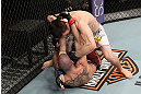 LAS VEGAS, NV - DECEMBER 15:  Timothy Elliott (top) punches Jared Papazian (bottom) during their flyweight fight at the TUF 16 Finale on December 15, 2012  at the Joint at the Hard Rock in Las Vegas, Nevada.  (Photo by Jim Kemper/Zuffa LLC/Zuffa LLC via Getty Images) *** Local Caption ***Jared Papazian; Timothy Elliott
