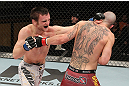 LAS VEGAS, NV - DECEMBER 15:  (L-R) Timothy Elliott punches Jared Papazian during their flyweight fight at the TUF 16 Finale on December 15, 2012  at the Joint at the Hard Rock in Las Vegas, Nevada.  (Photo by Jim Kemper/Zuffa LLC/Zuffa LLC via Getty Images) *** Local Caption ***Jared Papazian; Timothy Elliott