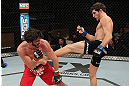 LAS VEGAS, NV - DECEMBER 15:  (R-L) John Cofer kicks Mike Rio during their lightweight fight at the TUF 16 Finale on December 15, 2012  at the Joint at the Hard Rock in Las Vegas, Nevada.  (Photo by Jim Kemper/Zuffa LLC/Zuffa LLC via Getty Images) *** Local Caption *** Mike Rio; John Cofer