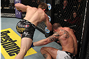 LAS VEGAS, NV - DECEMBER 15:  (L-R) T.J. Waldburger punches Nick Catone during their welterweight fight at the TUF 16 Finale on December 15, 2012  at the Joint at the Hard Rock in Las Vegas, Nevada.  (Photo by Jim Kemper/Zuffa LLC/Zuffa LLC via Getty Images) *** Local Caption *** T.J. Waldburger; Nick Catone