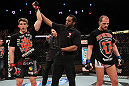 LAS VEGAS, NV - DECEMBER 15:  T.J. Waldburger (left) is announced the winner over Nick Catone (right) by referee Herb Dean after their welterweight fight at the TUF 16 Finale on December 15, 2012  at the Joint at the Hard Rock in Las Vegas, Nevada.  (Photo by Jim Kemper/Zuffa LLC/Zuffa LLC via Getty Images) *** Local Caption *** T.J. Waldburger; Nick Catone; Herb Dean