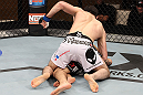 LAS VEGAS, NV - DECEMBER 15:  Rustam Khabilov (white shorts) punches Vinc Pichel during their lightweight fight at the TUF 16 Finale on December 15, 2012  at the Joint at the Hard Rock in Las Vegas, Nevada.  (Photo by Jim Kemper/Zuffa LLC/Zuffa LLC via Getty Images) *** Local Caption *** Vinc Pichel; Rustam Khabilov
