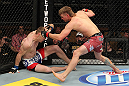 LAS VEGAS, NV - DECEMBER 15:  (R-L) Mike Pyle punches James Head during their welterweight fight at the TUF 16 Finale on December 15, 2012  at the Joint at the Hard Rock in Las Vegas, Nevada.  (Photo by Jim Kemper/Zuffa LLC/Zuffa LLC via Getty Images) *** Local Caption *** Mike Pyle; James Head