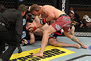 LAS VEGAS, NV - DECEMBER 15:  (R-L) Mike Pyle punches James Head as referee Steve Mazzagatti looks on during their welterweight fight at the TUF 16 Finale on December 15, 2012  at the Joint at the Hard Rock in Las Vegas, Nevada.  (Photo by Jim Kemper/Zuffa LLC/Zuffa LLC via Getty Images) *** Local Caption *** Mike Pyle; James Head