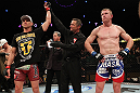 LAS VEGAS, NV - DECEMBER 15:  Mike Pyle (left) reacts to being declared the winner in his knockout victory over James Head (right) by referee Steve Mazzagatti during their welterweight fight at the TUF 16 Finale on December 15, 2012  at the Joint at the Hard Rock in Las Vegas, Nevada.  (Photo by Jim Kemper/Zuffa LLC/Zuffa LLC via Getty Images) *** Local Caption *** Mike Pyle; James Head; Steve Mazzagatti