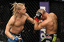 LAS VEGAS, NV - DECEMBER 15:  (L-R) Jonathan Brookins punches Dustin Poirier during their featherweight fight at the TUF 16 Finale on December 15, 2012  at the Joint at the Hard Rock in Las Vegas, Nevada.  (Photo by Jim Kemper/Zuffa LLC/Zuffa LLC via Getty Images) *** Local Caption *** Dustn Poirier; Jonathan Brookins