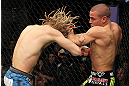 LAS VEGAS, NV - DECEMBER 15:  (R-L) Dustin Poirier punches Jonathan Brookins during their featherweight fight at the TUF 16 Finale on December 15, 2012  at the Joint at the Hard Rock in Las Vegas, Nevada.  (Photo by Jim Kemper/Zuffa LLC/Zuffa LLC via Getty Images) *** Local Caption *** Dustn Poirier; Jonathan Brookins