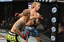 LAS VEGAS, NV - DECEMBER 15:  (L-R) Dustin Poirier punches Jonathan Brookins during their featherweight fight at the TUF 16 Finale on December 15, 2012  at the Joint at the Hard Rock in Las Vegas, Nevada.  (Photo by Jim Kemper/Zuffa LLC/Zuffa LLC via Getty Images) *** Local Caption *** Dustn Poirier; Jonathan Brookins