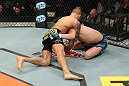 LAS VEGAS, NV - DECEMBER 15:  Dustin Poirier (black shorts) attempts to submit Jonathan Brookins during their featherweight fight at the TUF 16 Finale on December 15, 2012  at the Joint at the Hard Rock in Las Vegas, Nevada.  (Photo by Jim Kemper/Zuffa LLC/Zuffa LLC via Getty Images) *** Local Caption *** Dustn Poirier; Jonathan Brookins