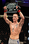 LAS VEGAS, NV - DECEMBER 15:  Colton Smith lifts the Ultimate Fighter season 16 trophy after his lightweight fight at the TUF 16 Finale on December 15, 2012  at the Joint at the Hard Rock in Las Vegas, Nevada.  (Photo by Jim Kemper/Zuffa LLC/Zuffa LLC via Getty Images) *** Local Caption *** Colton Smith; Mike Ricci