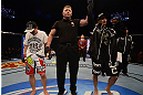 LAS VEGAS, NV - DECEMBER 29:  John Moraga (right) is declared the winner over Chris Cariaso (left) after their flyweight fight at UFC 155 on December 29, 2012 at MGM Grand Garden Arena in Las Vegas, Nevada. (Photo by Donald Miralle/Zuffa LLC/Zuffa LLC via Getty Images) *** Local Caption *** Chris Cariaso; John Moraga