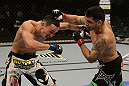 LAS VEGAS, NV - DECEMBER 29:  (R-L) Leonard Garcia punches Max Holloway during their featherweight fight at UFC 155 on December 29, 2012 at MGM Grand Garden Arena in Las Vegas, Nevada. (Photo by Donald Miralle/Zuffa LLC/Zuffa LLC via Getty Images) *** Local Caption *** Leonard Garcia; Max Holloway