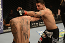 LAS VEGAS, NV - DECEMBER 29:  (R-L) Leonard Garcia punches Max Holloway during their featherweight fight at UFC 155 on December 29, 2012 at MGM Grand Garden Arena in Las Vegas, Nevada. (Photo by Donald Miralle/Zuffa LLC/Zuffa LLC via Getty Images) *** Local Caption *** Leonard Garcia; Max Holloway