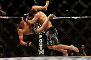LAS VEGAS, NV - DECEMBER 29:  (R-L) Leonard Garcia slams Max Holloway during their featherweight fight at UFC 155 on December 29, 2012 at MGM Grand Garden Arena in Las Vegas, Nevada. (Photo by Josh Hedges/Zuffa LLC/Zuffa LLC via Getty Images) *** Local Caption *** Leonard Garcia; Max Holloway