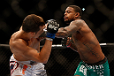 LAS VEGAS, NV - DECEMBER 29:  (R-L) Michael Johnson punches Myles Jury during their lightweight fight at UFC 155 on December 29, 2012 at MGM Grand Garden Arena in Las Vegas, Nevada. (Photo by Josh Hedges/Zuffa LLC/Zuffa LLC via Getty Images) *** Local Caption *** Michael Johnson; Myles Jury