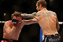 LAS VEGAS, NV - DECEMBER 29:  (R-L) Eddie Wineland punches Brad Pickett during their bantamweight fight at UFC 155 on December 29, 2012 at MGM Grand Garden Arena in Las Vegas, Nevada. (Photo by Josh Hedges/Zuffa LLC/Zuffa LLC via Getty Images) *** Local Caption *** Brad Pickett; Eddie Wineland