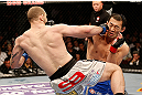 LAS VEGAS, NV - DECEMBER 29:  (L-R) Alan Belcher punches Yushin Okami during their middleweight fight at UFC 155 on December 29, 2012 at MGM Grand Garden Arena in Las Vegas, Nevada. (Photo by Josh Hedges/Zuffa LLC/Zuffa LLC via Getty Images) *** Local Caption *** Yushin Okami; Alan Belcher
